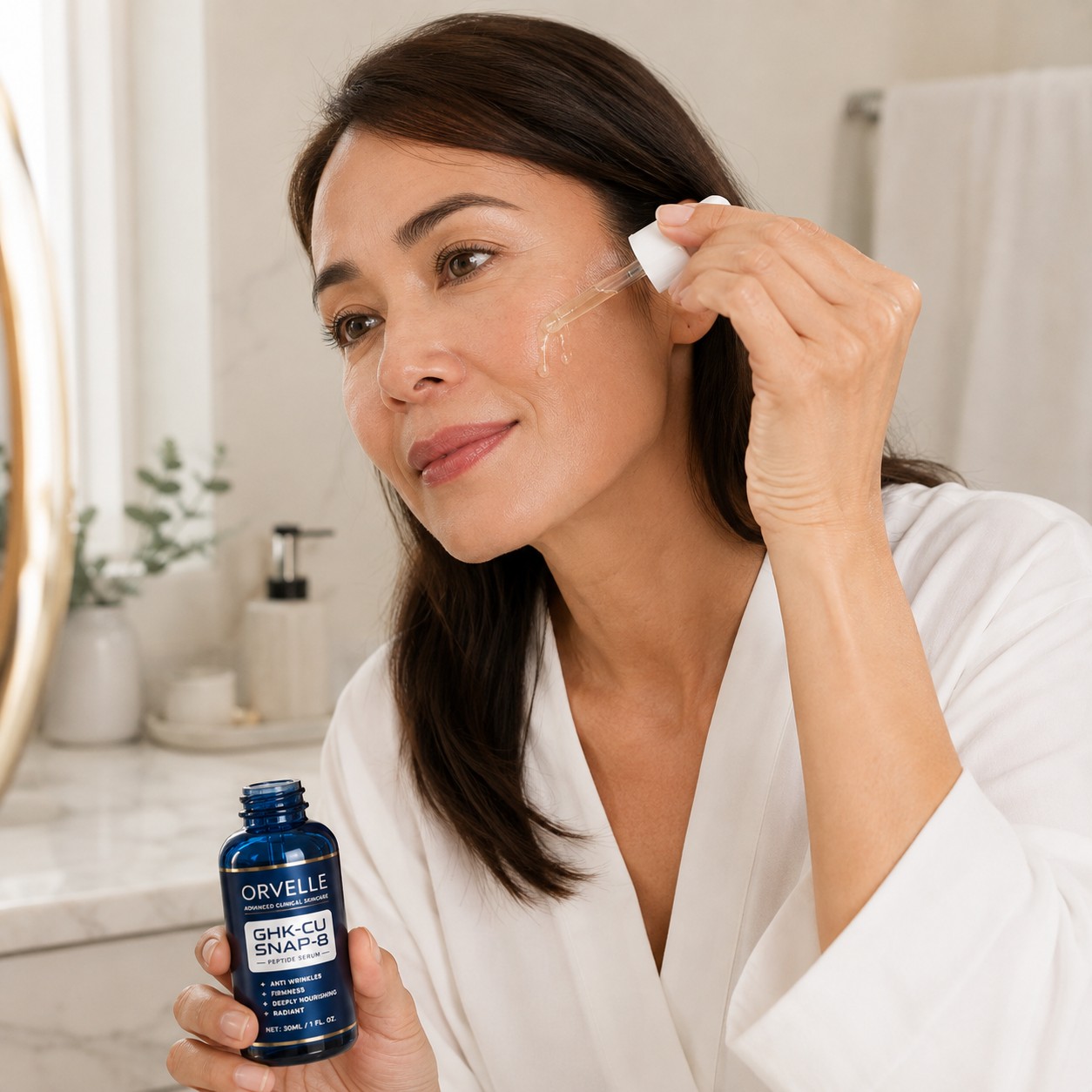 Woman applying Orvelle serum to her face with a dropper