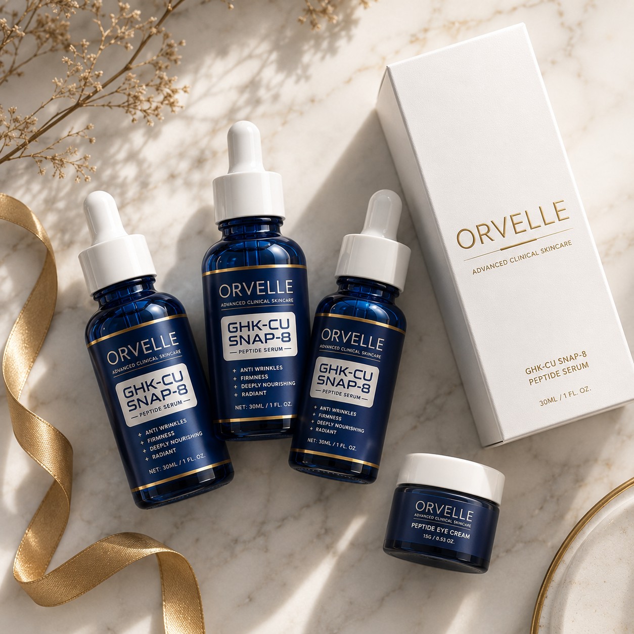 Orvelle 3-bottle bundle with bonus eye cream, flat lay on marble